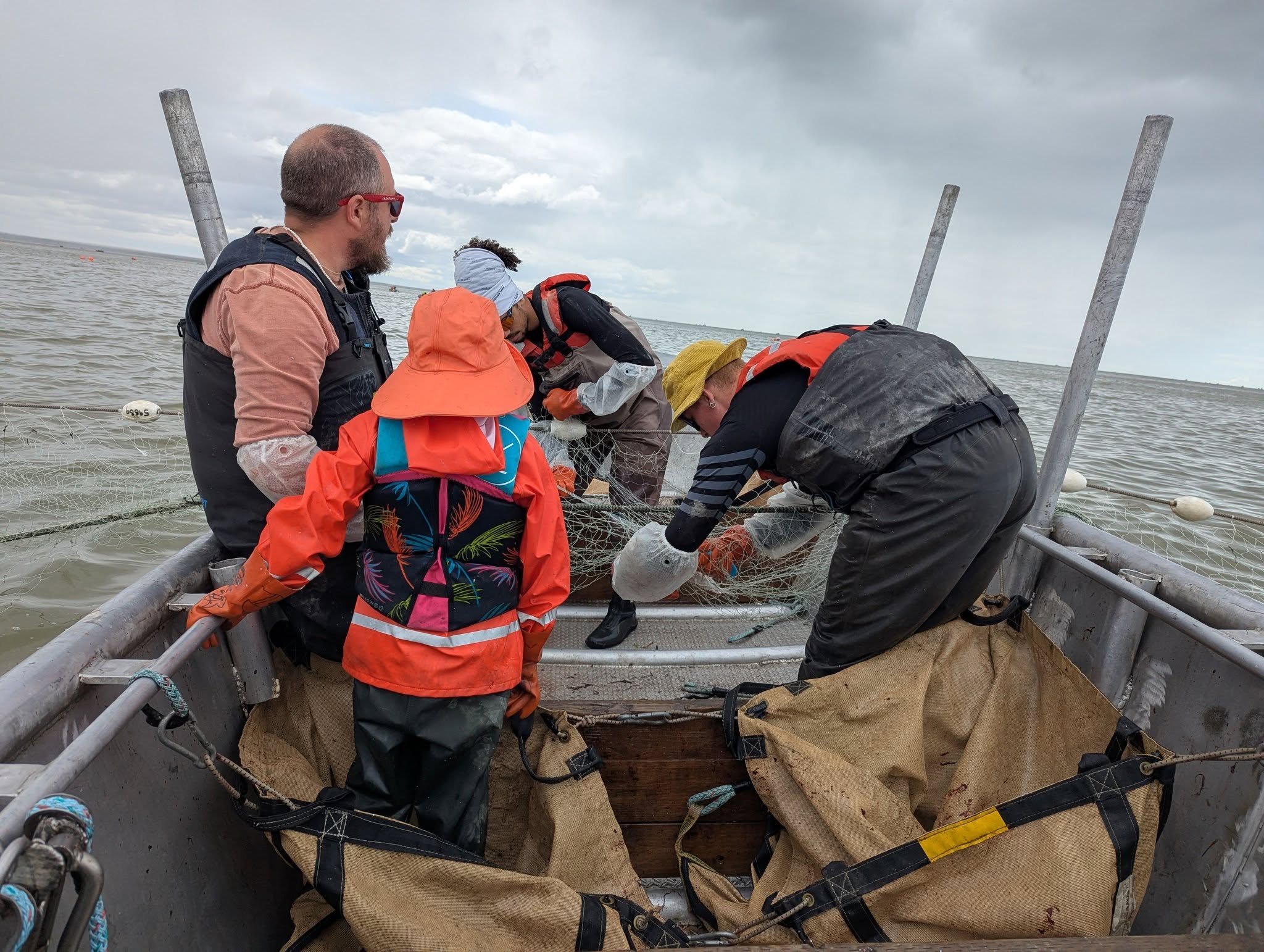 Fishing crew working with nets on boat